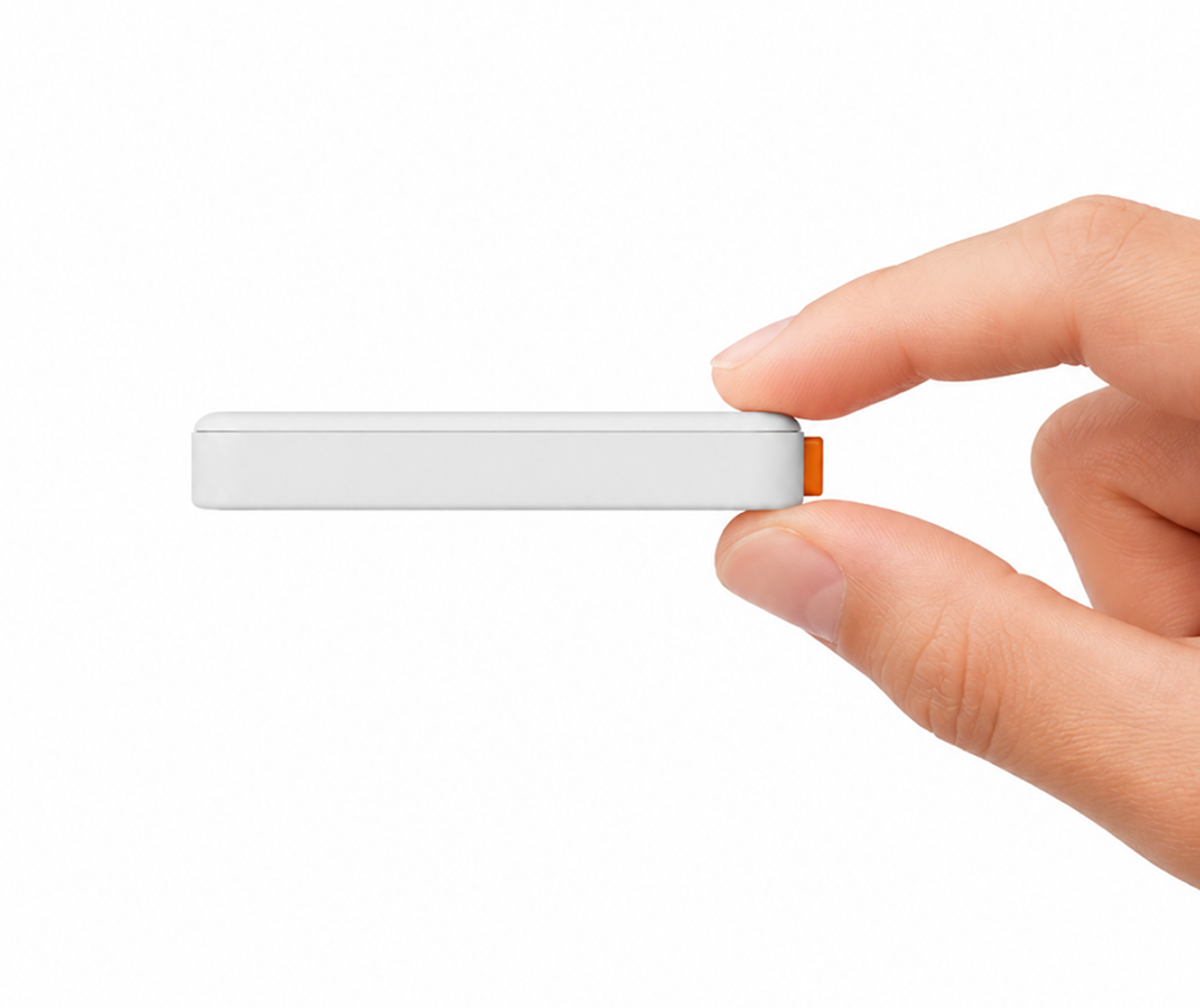 Thin side view of Tiny Tome held between fingers
